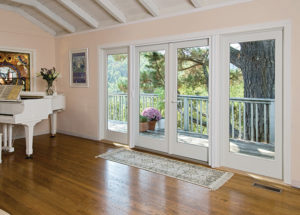 A pink living room with wood floors and white patio doors