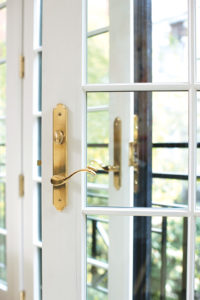 Picture of a glass door with the golden color door accessories